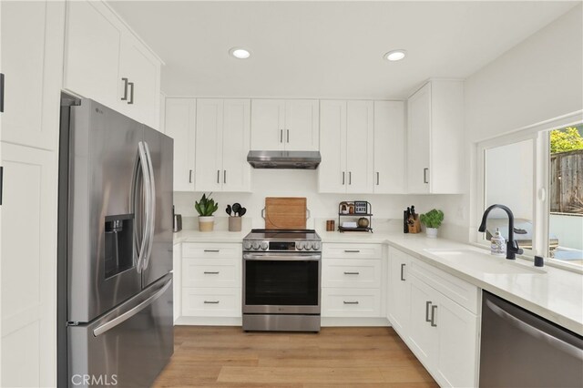 27322 Eastridge Dr, Lake Forest, CA 92630 - kitchen featuring stainless steel appliances, under cabinet range hood, white cabinetry, light countertops, and recessed lighting