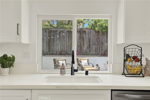 27322 Eastridge Dr, Lake Forest, CA 92630 - detailed view of dishwasher, white cabinetry, and light stone counters