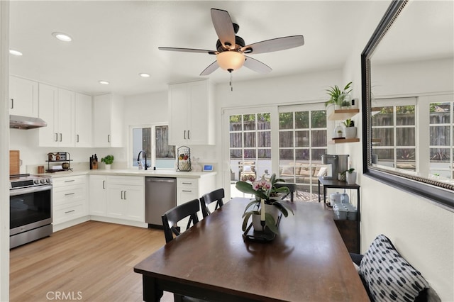 27322 Eastridge Dr, Lake Forest, CA 92630 - kitchen with appliances with stainless steel finishes, under cabinet range hood, white cabinets, light wood-style floors, and a ceiling fan