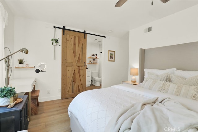 27322 Eastridge Dr, Lake Forest, CA 92630 - bedroom featuring a barn door, light wood-style floors, ensuite bathroom, and a ceiling fan