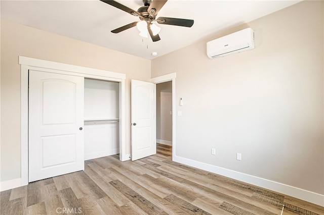 836 Regnier Ln, Paradise, CA 95969 - unfurnished bedroom with an AC wall unit, light wood-style floors, a closet, and a ceiling fan