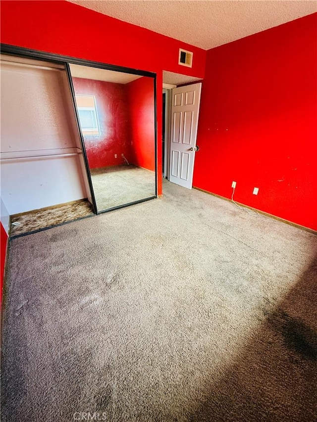 4043 Utah St Unit 8, San Diego, CA 92104 - unfurnished bedroom featuring carpet, a closet, and a textured ceiling