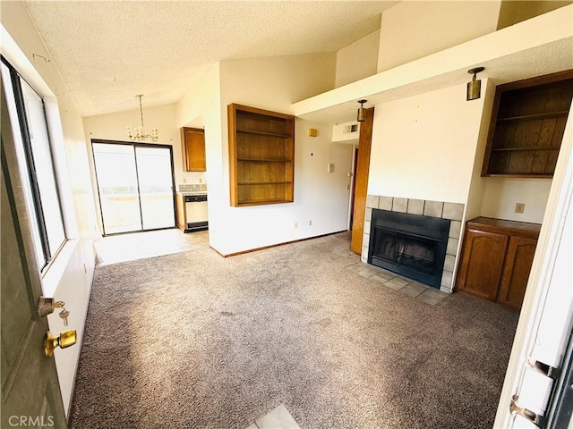 4043 Utah St Unit 8, San Diego, CA 92104 - unfurnished living room with light carpet, vaulted ceiling, a textured ceiling, a tiled fireplace, and a chandelier