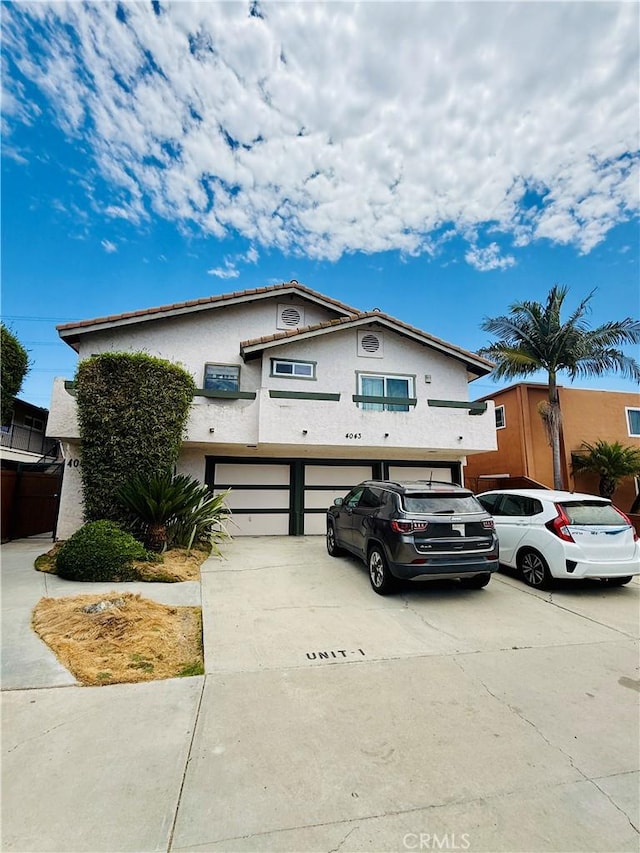 4043 Utah St Unit 8, San Diego, CA 92104 - view of front of house with an attached garage, stucco siding, and driveway