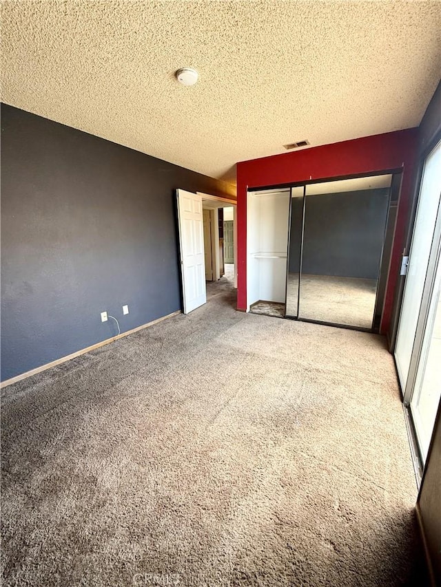 4043 Utah St Unit 8, San Diego, CA 92104 - unfurnished bedroom with carpet flooring, a textured ceiling, and two closets