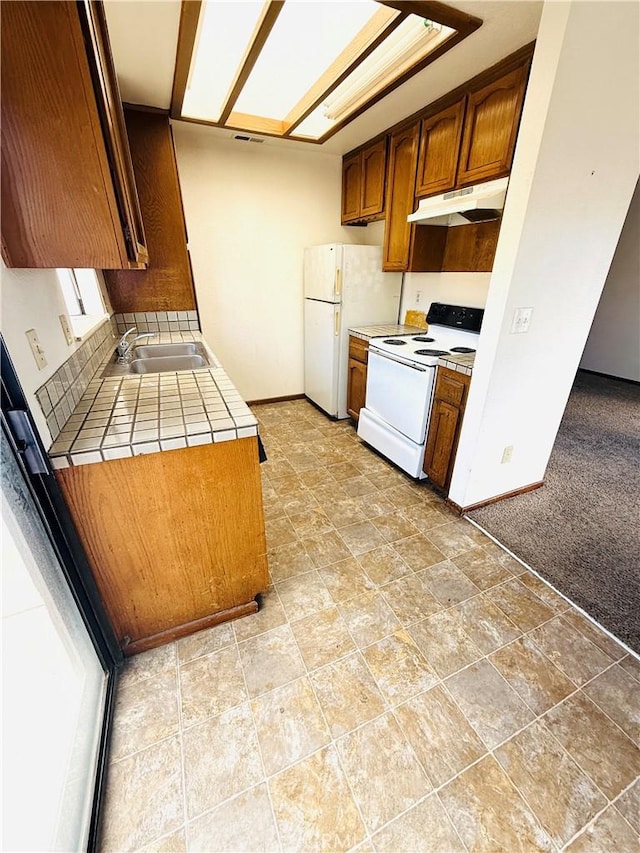 4043 Utah St Unit 8, San Diego, CA 92104 - kitchen featuring white appliances, under cabinet range hood, tile countertops, and brown cabinets