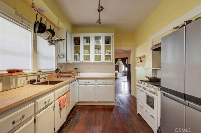 571 W 17th St, San Pedro, CA 90731 - kitchen featuring white appliances, tasteful backsplash, dark wood-style flooring, and healthy amount of natural light