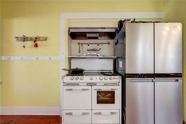 571 W 17th St, San Pedro, CA 90731 - kitchen featuring freestanding refrigerator, range with two ovens, wood finished floors, and under cabinet range hood