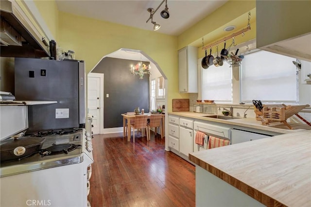 571 W 17th St, San Pedro, CA 90731 - kitchen with a chandelier, white cabinetry, dark wood-style flooring, light countertops, and dishwashing machine