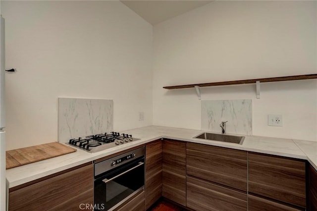 571 W 17th St, San Pedro, CA 90731 - kitchen with stainless steel appliances, decorative backsplash, modern cabinets, light countertops, and brown cabinets