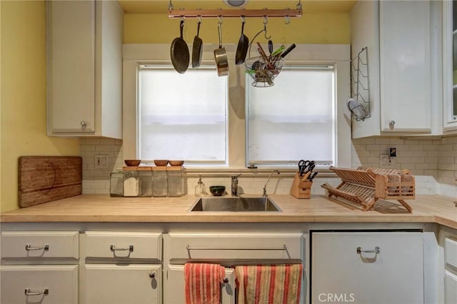 571 W 17th St, San Pedro, CA 90731 - kitchen featuring decorative backsplash, light countertops, and white cabinetry