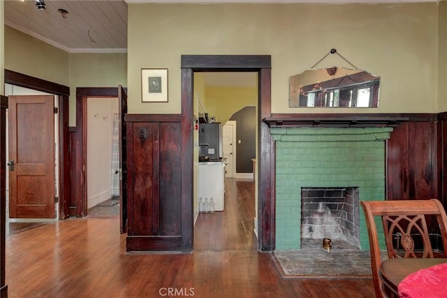 571 W 17th St, San Pedro, CA 90731 - living room with wood finished floors, ornamental molding, and a brick fireplace