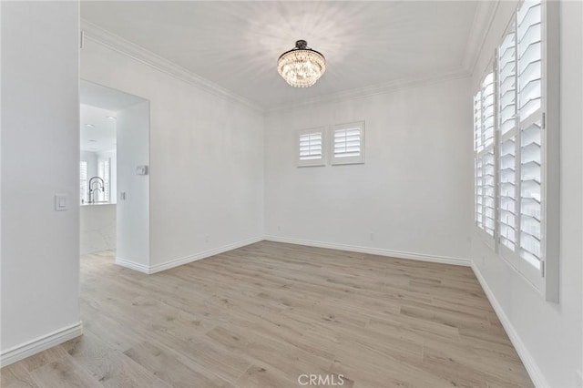 49 Eaglecreek, Irvine, CA 92618 - spare room with a chandelier, plenty of natural light, light wood-type flooring, and crown molding