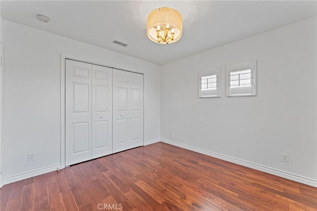 49 Eaglecreek, Irvine, CA 92618 - unfurnished bedroom with wood finished floors, a chandelier, and a closet