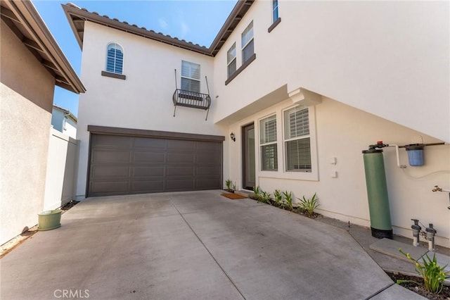 49 Eaglecreek, Irvine, CA 92618 - mediterranean / spanish-style home with an attached garage, concrete driveway, stucco siding, and a balcony