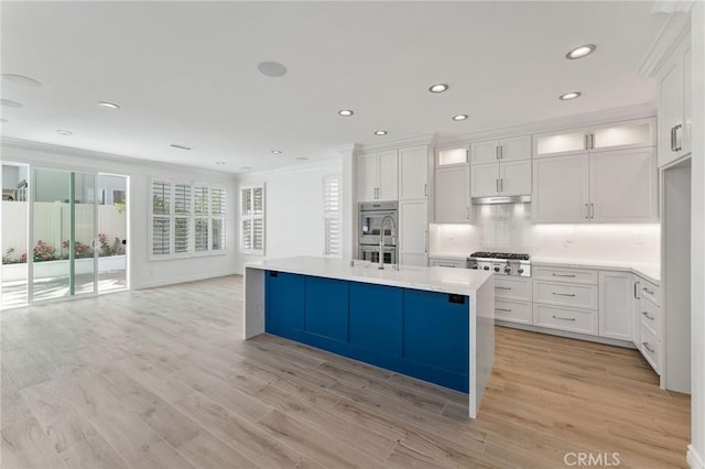 49 Eaglecreek, Irvine, CA 92618 - kitchen featuring white cabinets, ornamental molding, recessed lighting, appliances with stainless steel finishes, and light countertops