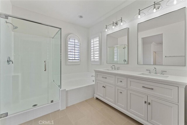 49 Eaglecreek, Irvine, CA 92618 - bathroom featuring a stall shower, a bath, double vanity, and tile patterned floors