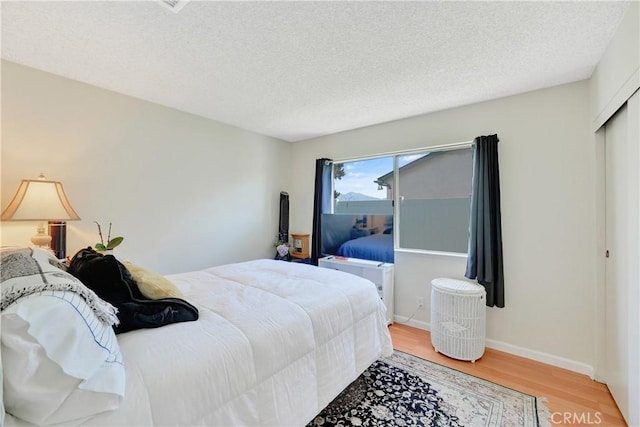 3966 Laurel Ct, Chino Hills, CA 91709 - bedroom with light wood-type flooring, a textured ceiling, and a closet