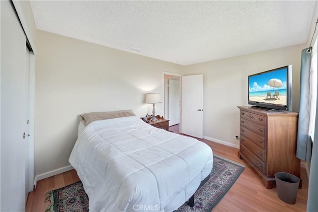 3966 Laurel Ct, Chino Hills, CA 91709 - bedroom with light wood finished floors, a textured ceiling, and a closet
