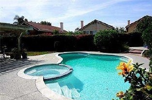 13067 Winterpark Way, Riverside, CA 92503 - view of pool featuring a pool with connected hot tub, a fenced backyard, and a patio