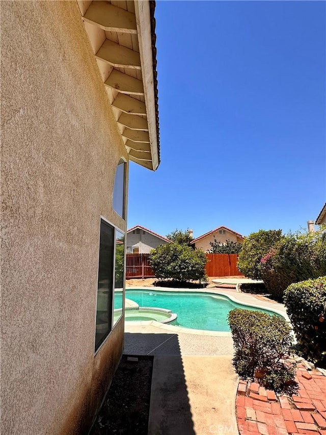 13067 Winterpark Way, Riverside, CA 92503 - view of pool with a pool with connected hot tub, a fenced backyard, and a patio