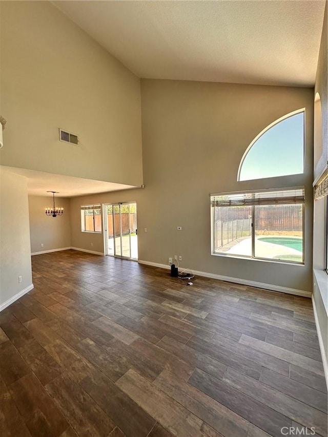 13067 Winterpark Way, Riverside, CA 92503 - unfurnished living room featuring high vaulted ceiling, a chandelier, and dark wood-style floors