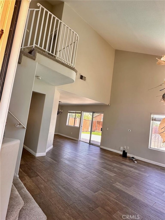 13067 Winterpark Way, Riverside, CA 92503 - unfurnished living room featuring a high ceiling, a chandelier, and dark wood finished floors