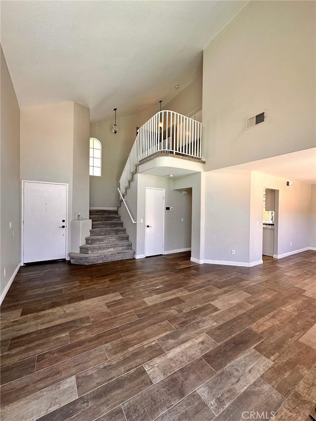 13067 Winterpark Way, Riverside, CA 92503 - unfurnished living room with stairs, wood finished floors, and a high ceiling