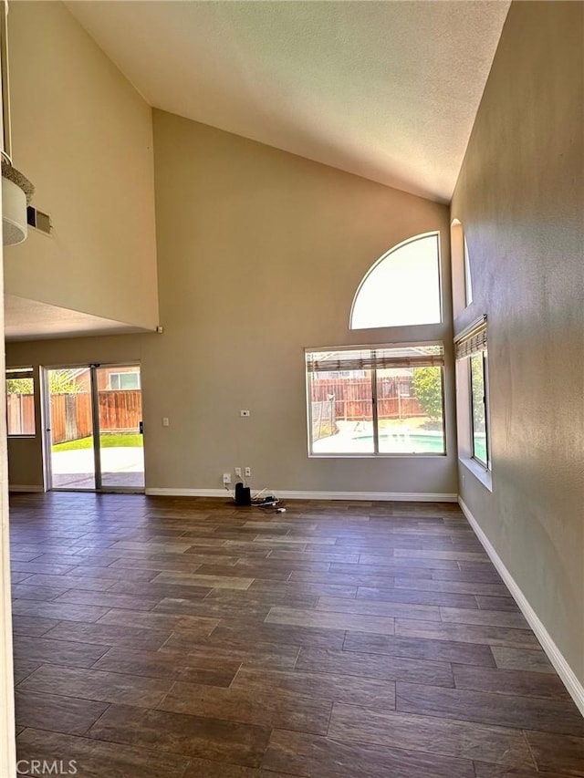 13067 Winterpark Way, Riverside, CA 92503 - unfurnished living room with high vaulted ceiling and dark wood-style floors