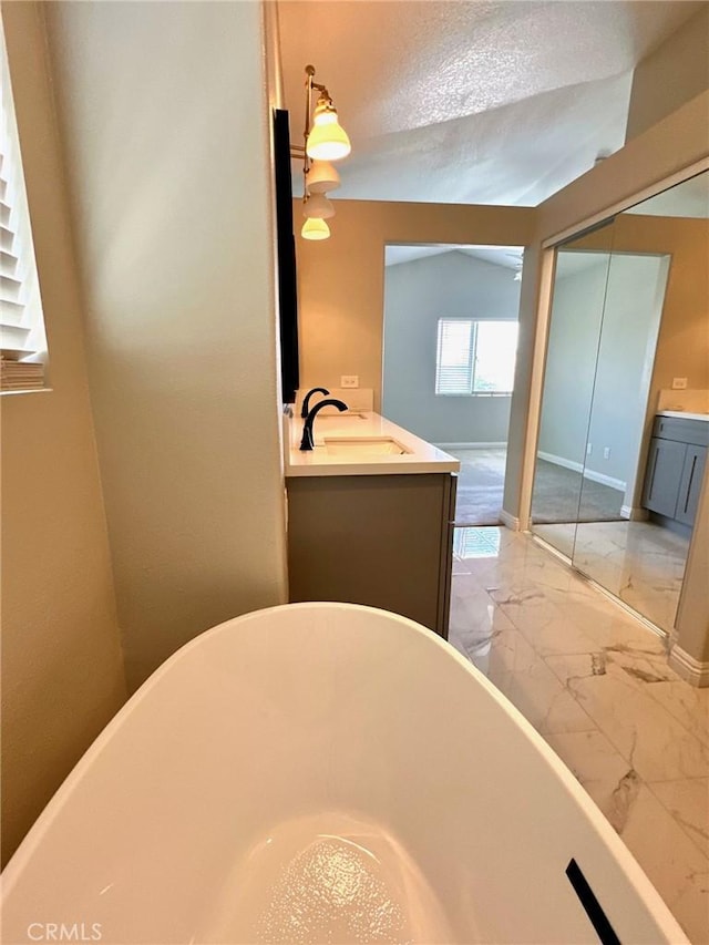 13067 Winterpark Way, Riverside, CA 92503 - full bathroom featuring marble look tiles, a soaking tub, and vanity