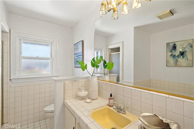9662 Crosby Ave, Garden Grove, CA 92844 - full bathroom featuring a stall shower, vanity, tile walls, and a chandelier