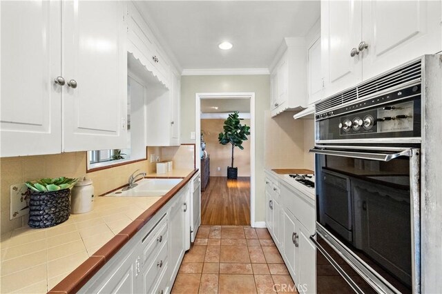 9662 Crosby Ave, Garden Grove, CA 92844 - kitchen featuring tile countertops, white appliances, white cabinets, and crown molding