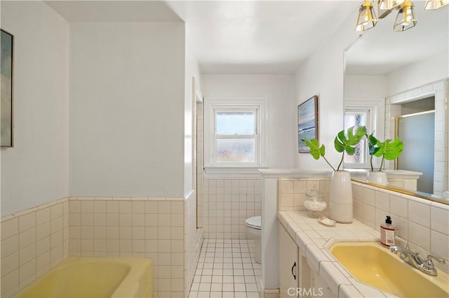 9662 Crosby Ave, Garden Grove, CA 92844 - full bathroom with tile walls, tile patterned floors, a bath, vanity, and a shower with door