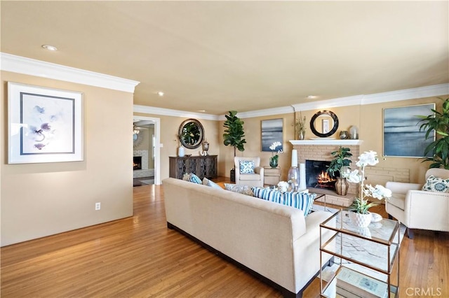 9662 Crosby Ave, Garden Grove, CA 92844 - living area featuring a brick fireplace, light wood-style floors, crown molding, and recessed lighting