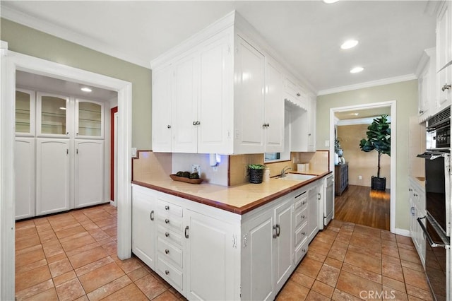 9662 Crosby Ave, Garden Grove, CA 92844 - kitchen featuring white cabinetry, crown molding, light countertops, white dishwasher, and recessed lighting