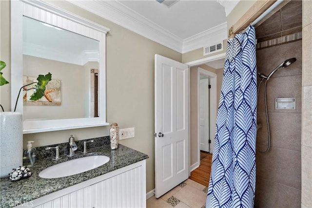 9662 Crosby Ave, Garden Grove, CA 92844 - bathroom with a tile shower, crown molding, vanity, and tile patterned flooring