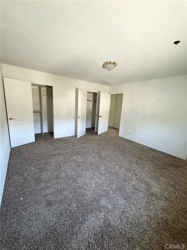 32161 Zircon Rd, Lucerne Valley, CA 92356 - unfurnished bedroom with a textured ceiling, multiple closets, and carpet