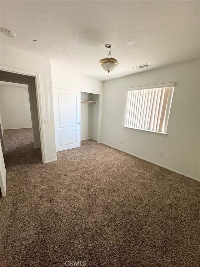 32161 Zircon Rd, Lucerne Valley, CA 92356 - unfurnished bedroom with carpet flooring, a textured ceiling, and a closet