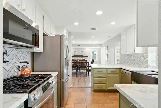 1440 Amanda Pl, Upland, CA 91784 - kitchen featuring appliances with stainless steel finishes, tasteful backsplash, light stone counters, recessed lighting, and white cabinets