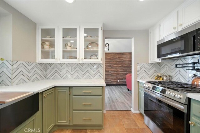 1440 Amanda Pl, Upland, CA 91784 - kitchen with green cabinets, stainless steel appliances, light countertops, and white cabinetry