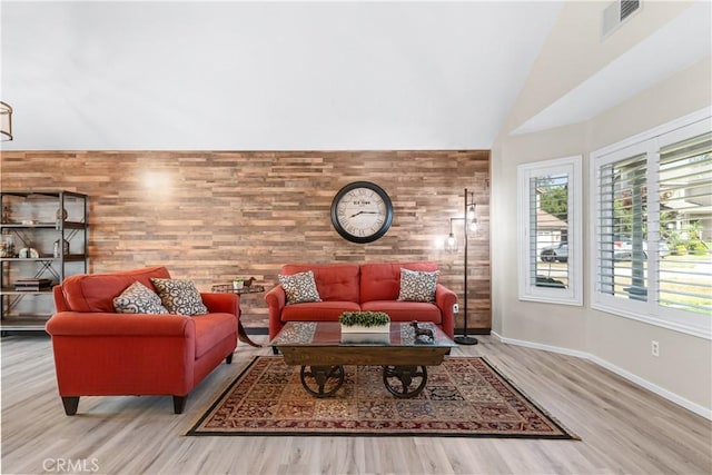 1440 Amanda Pl, Upland, CA 91784 - living area with healthy amount of natural light, lofted ceiling, wood finished floors, and wooden walls