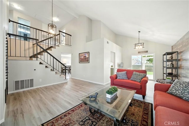 1440 Amanda Pl, Upland, CA 91784 - living area with high vaulted ceiling, wood finished floors, a chandelier, stairway, and beamed ceiling