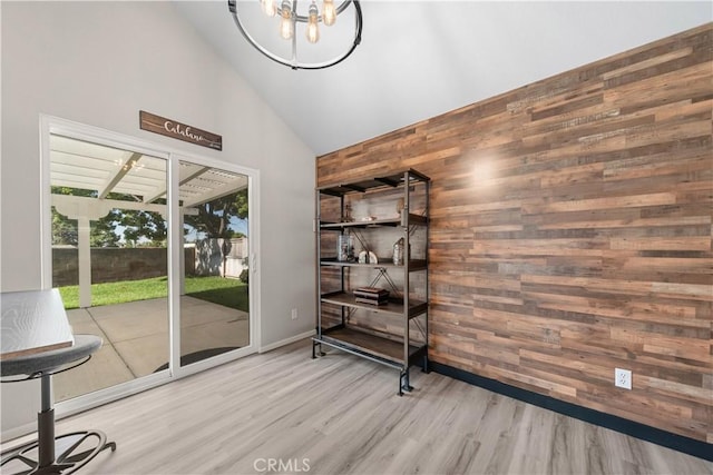 1440 Amanda Pl, Upland, CA 91784 - unfurnished dining area with wood walls, high vaulted ceiling, wood finished floors, and a chandelier