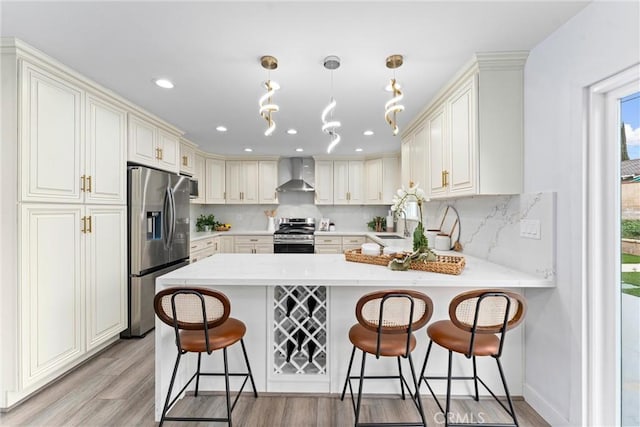 4802 Brookway Ave, Yorba Linda, CA 92886 - kitchen with appliances with stainless steel finishes, wall chimney exhaust hood, a peninsula, light wood finished floors, and backsplash