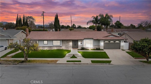 4802 Brookway Ave, Yorba Linda, CA 92886 - ranch-style house featuring a tile roof, stone siding, stucco siding, a lawn, and driveway