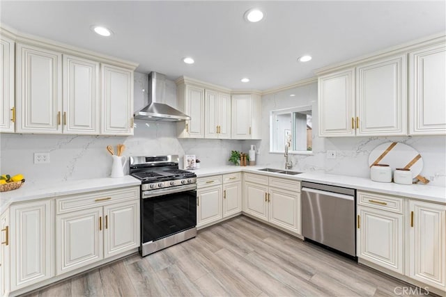 4802 Brookway Ave, Yorba Linda, CA 92886 - kitchen featuring appliances with stainless steel finishes, wall chimney exhaust hood, decorative backsplash, light wood-type flooring, and recessed lighting