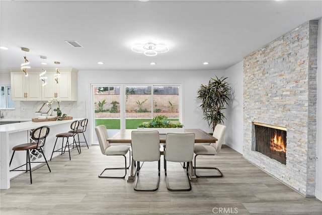 4802 Brookway Ave, Yorba Linda, CA 92886 - dining space featuring light wood-style flooring, recessed lighting, and a stone fireplace