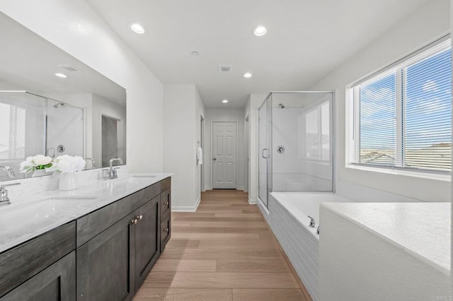 28339 Levi Way, Menifee, CA 92585 - full bath featuring a stall shower, double vanity, wood finished floors, a bath, and recessed lighting