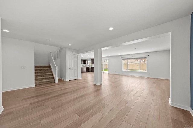 28339 Levi Way, Menifee, CA 92585 - unfurnished living room with stairway, light wood-style floors, and recessed lighting