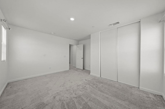 28339 Levi Way, Menifee, CA 92585 - unfurnished bedroom with light carpet, a closet, and recessed lighting
